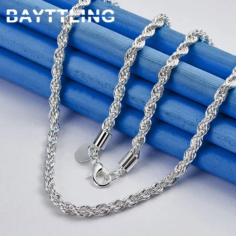 Silver rope chain necklace on blue and white background
