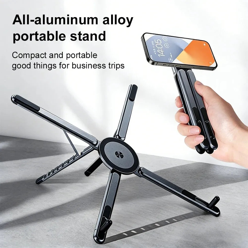Grey foldable aluminum alloy magnetic stand being held by hand and in use on a table