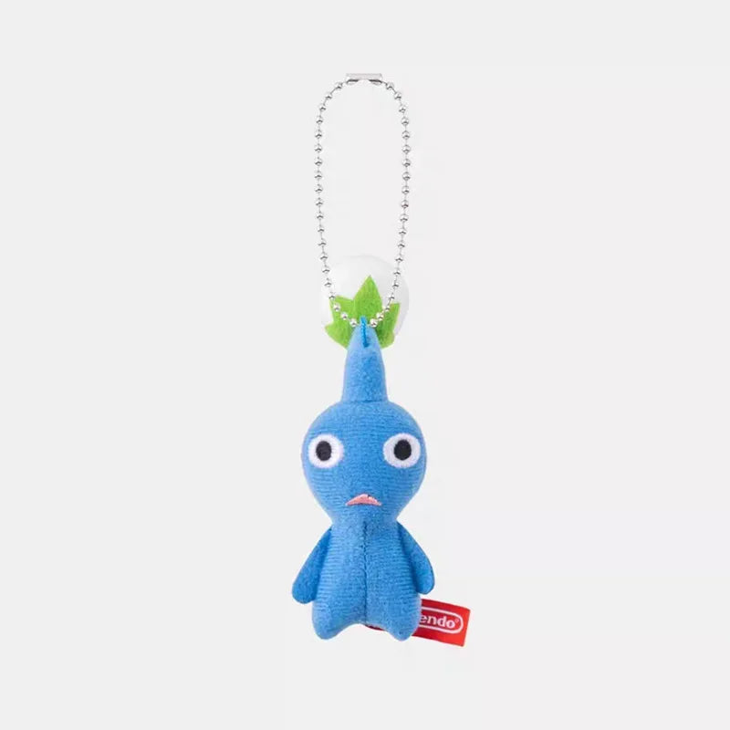 A small blue plush doll keychain with a white leaf on its head