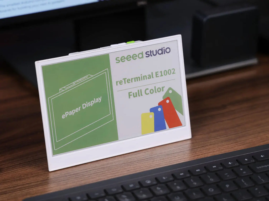 7.3 inch full color e-paper display on a desk next to a keyboard