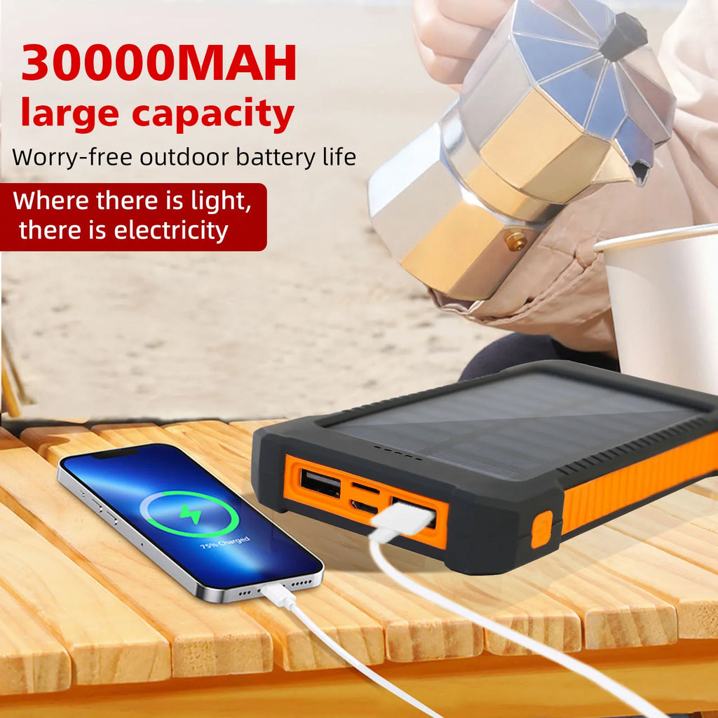 High capacity solar power bank charging a smartphone outdoors on a wooden table