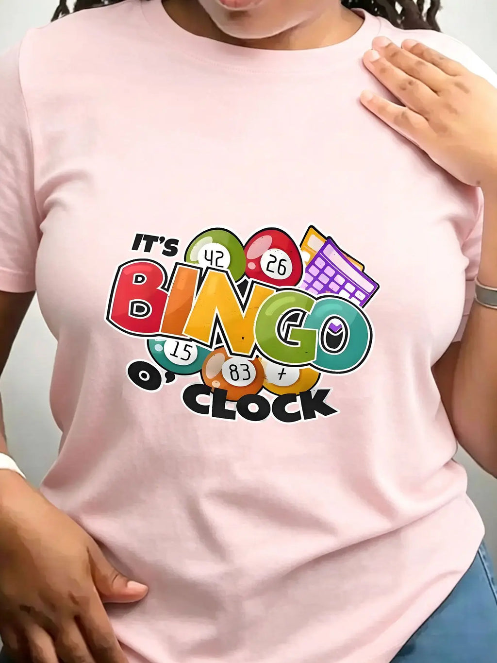 Light pink crew neck t-shirt with colourful bingo-themed graphic on front