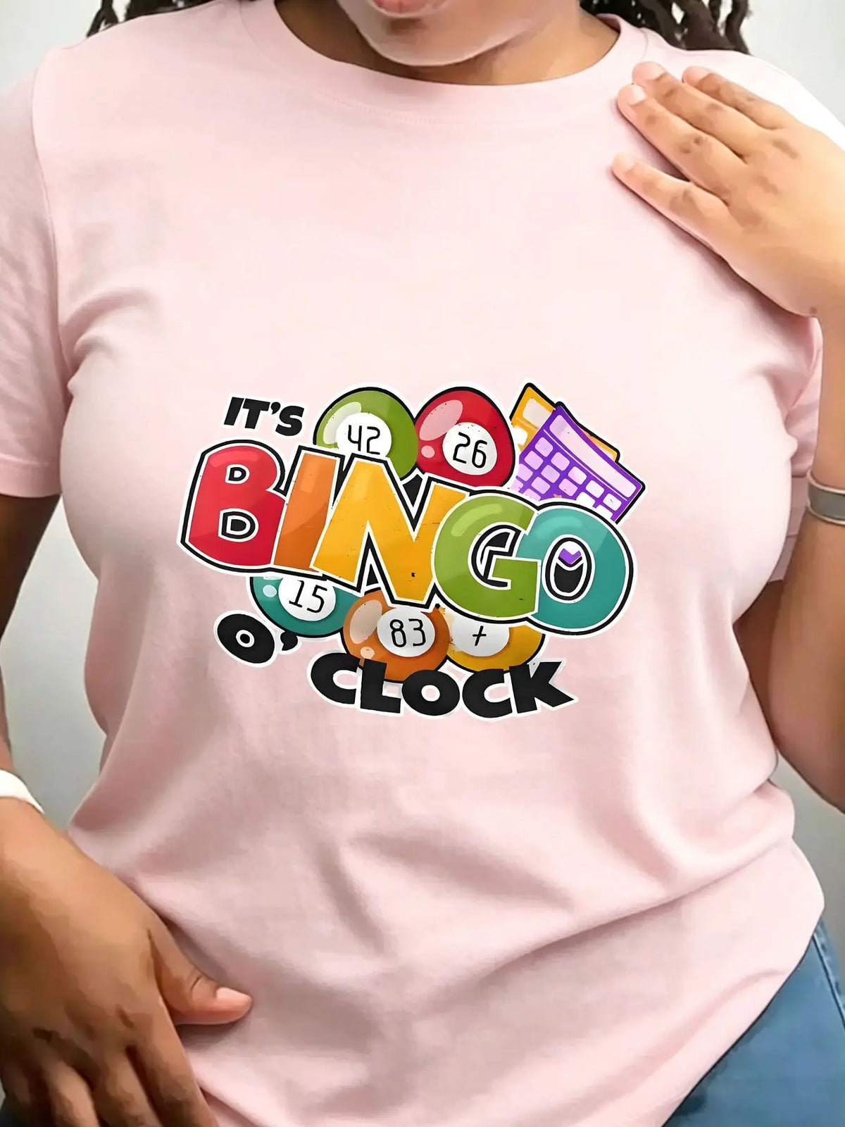 Light pink crew neck t-shirt with colourful bingo-themed graphic on front