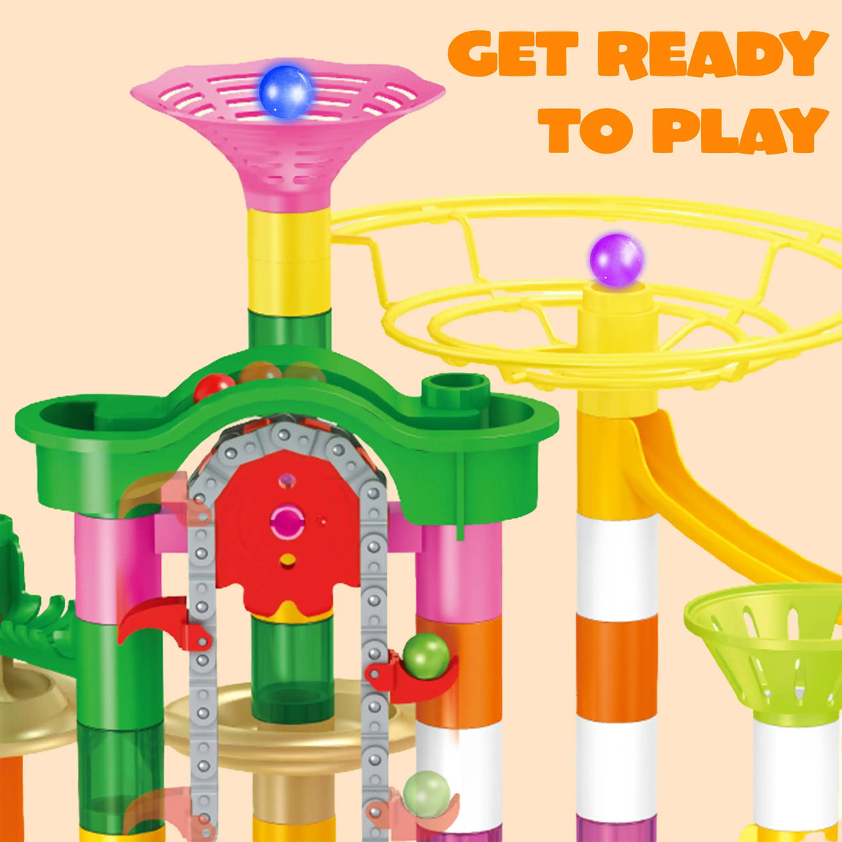 Close up of a marble run toy featuring a motorized elevator and pink funnel.
