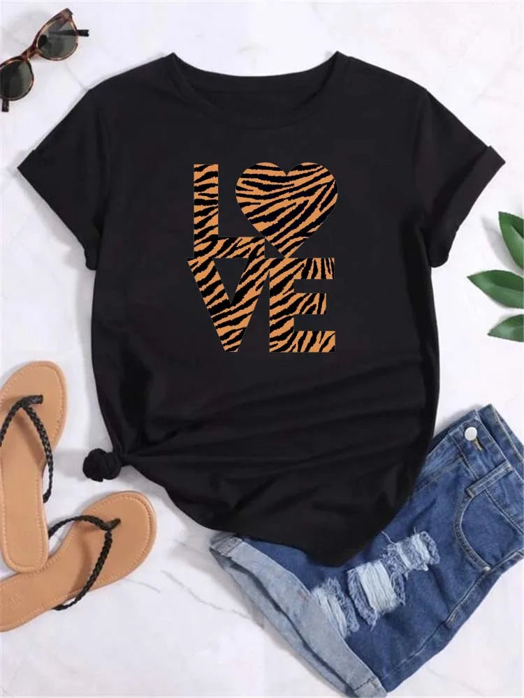 Black short sleeve t-shirt with tiger stripe pattern heart graphic, paired with denim shorts and sandals