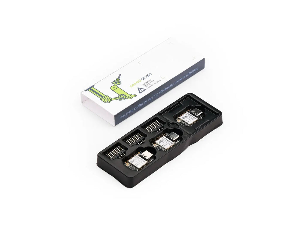 Three ESP32-S3 microcontroller development boards inside a black plastic packaging tray with a product box.