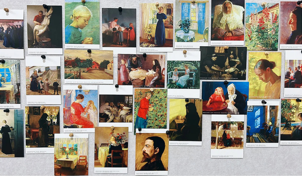 Many classical art postcards featuring portraits and interior scenes pinned to a display board.