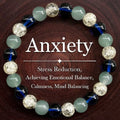 Beaded elastic bracelet with blue, light green and crackled clear beads on a dark wood background