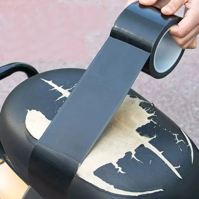 Hand applying a strip of black adhesive leather patch to a torn motorcycle seat