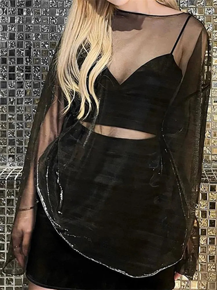 Back view of black sheer mesh long-sleeve oversized t-shirt worn over a black crop top