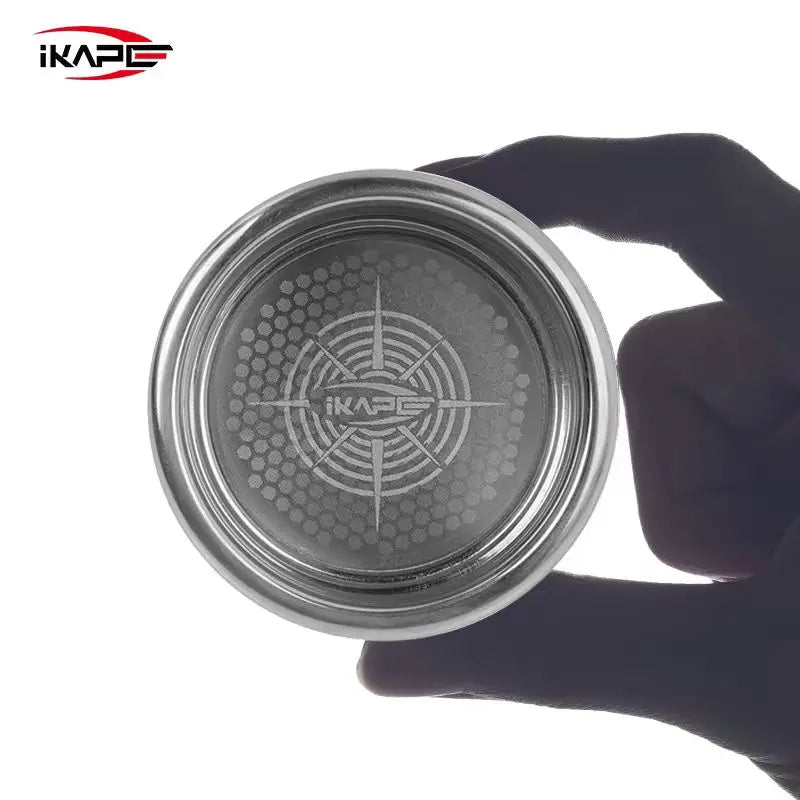 Stainless steel beehive espresso filter basket being held by a hand