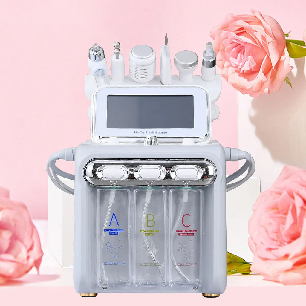 6-in-1 oxygen facial machine for skincare, white and grey design with three solution bottles, in front of pink flowers