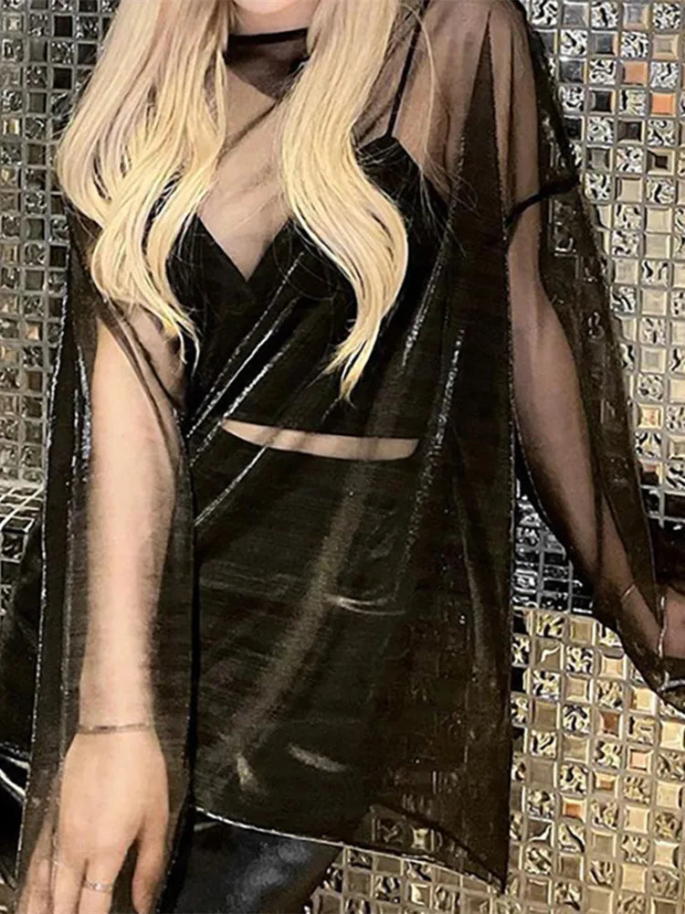 Black sheer mesh long-sleeve oversized t-shirt worn over a black crop top