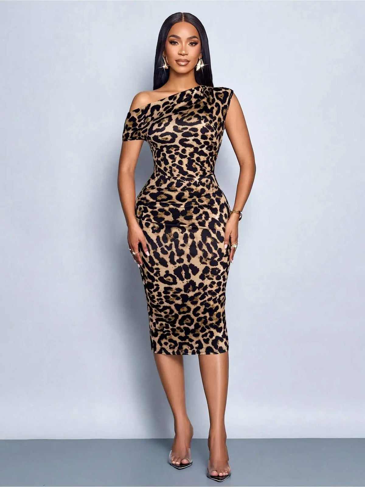 Woman wearing a fitted leopard print midi dress with an off-shoulder neckline, hands resting on sides
