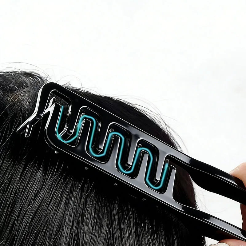 Close-up showing a black styling comb being used to texture hair