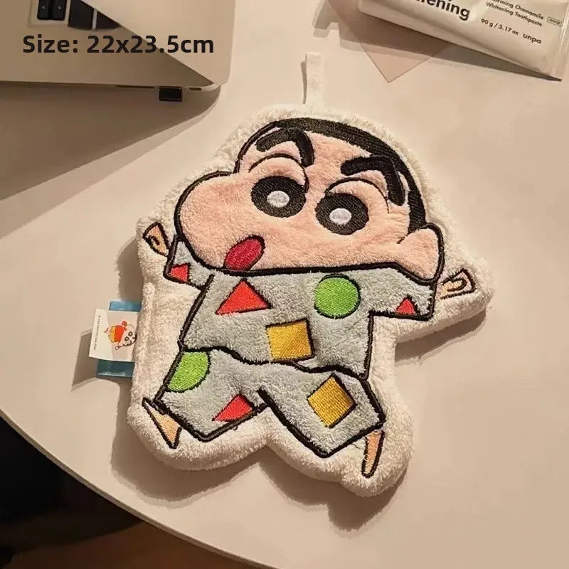 A cartoon-themed hanging hand towel shaped like a boy resting on a laptop keyboard with dimensions displayed.