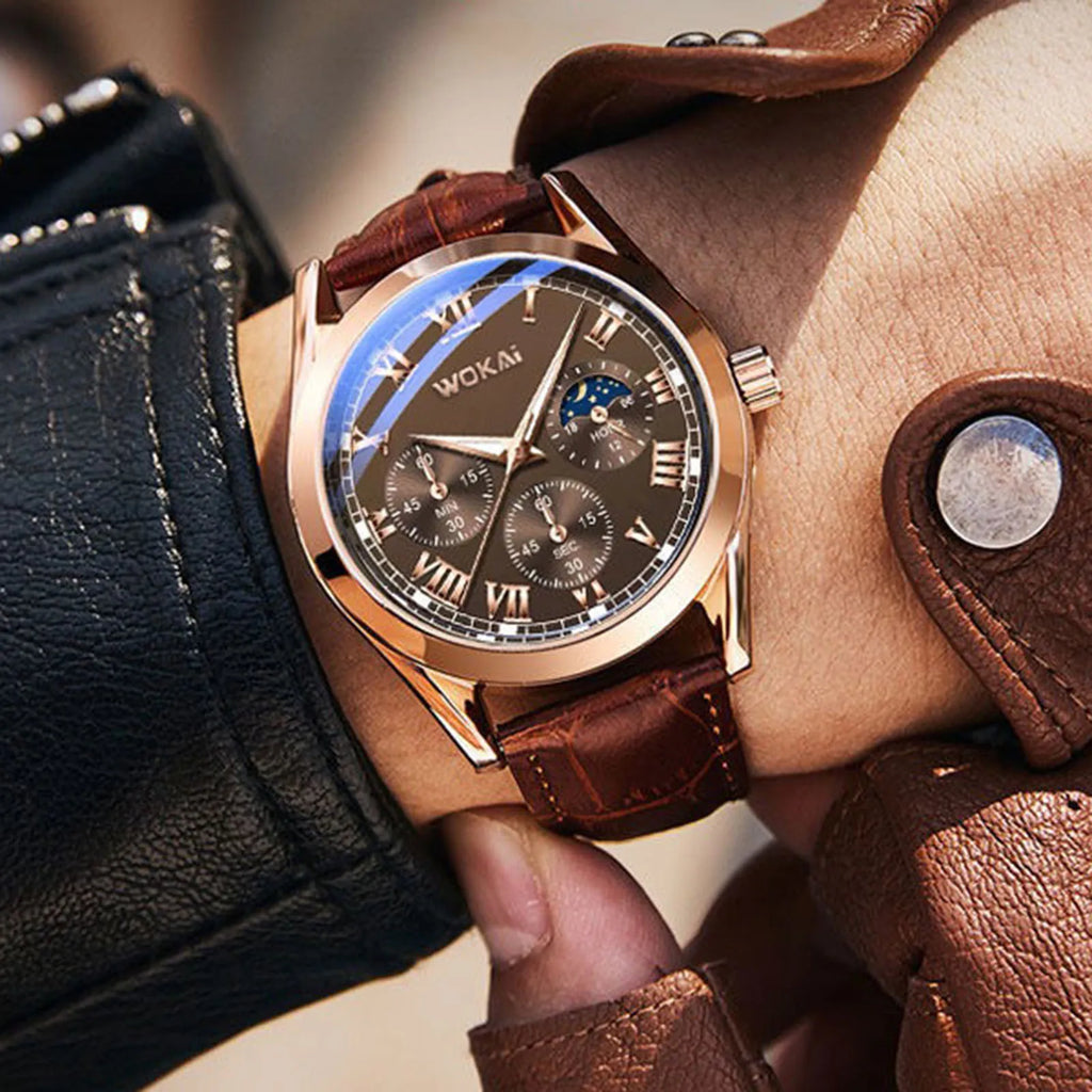Rose gold tone quartz watch with brown leather strap worn on a wrist, viewed from an angle