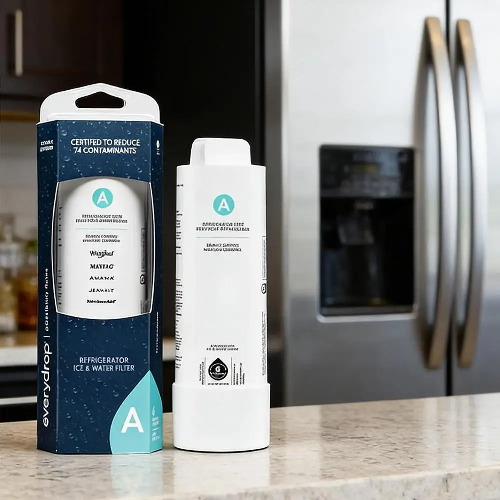 Refrigerator water filter standing next to its box on a kitchen counter in front of a stainless steel fridge