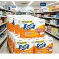 A large display of multi-roll packs of bathroom tissue stocked on a supermarket store shelf