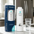 White cylinder refrigerator ice and water filter with its product packaging box on a kitchen counter