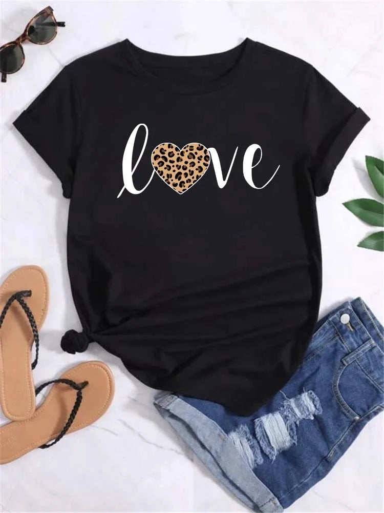 Black short sleeve t-shirt with leopard print heart graphic, paired with denim shorts and sandals