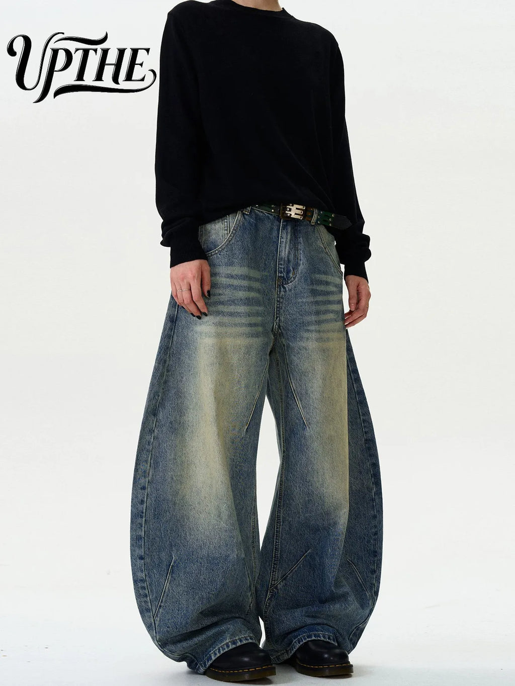 Model wearing vintage washed baggy wide leg denim jeans with black shirt