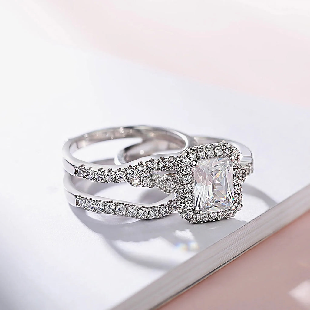 Sterling silver engagement ring set with rectangular moissanite stone and pave bands