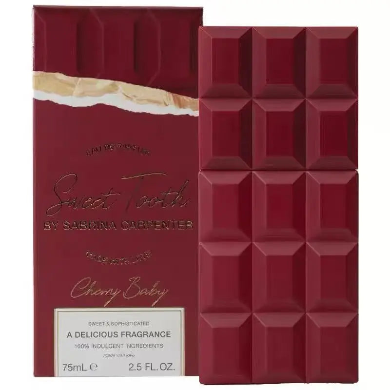 A red perfume bottle shaped like a chocolate bar next to its matching packaging box.