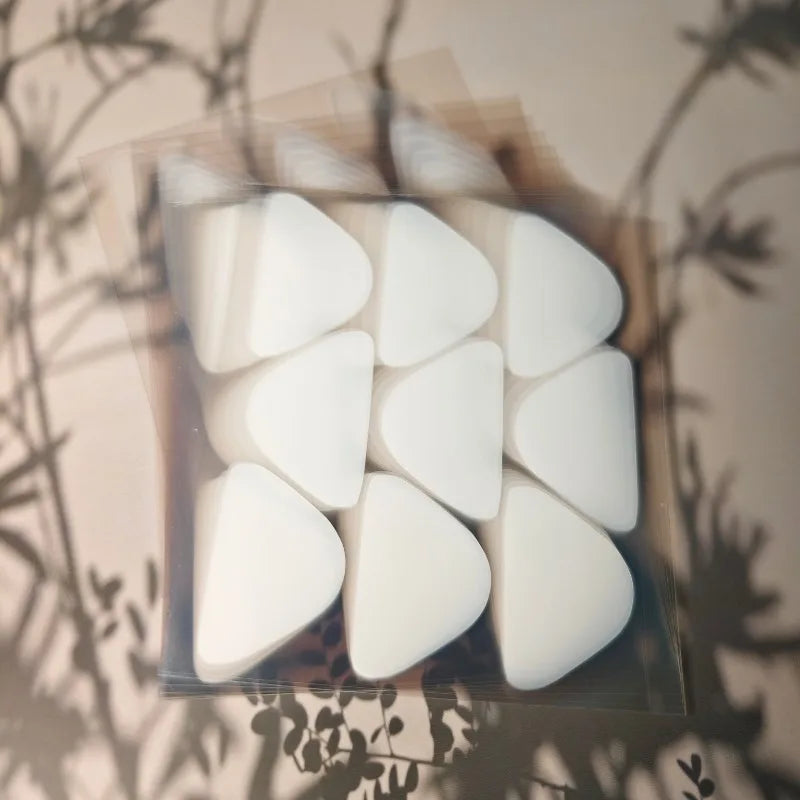 A stack of transparent sheets containing triangular anti-wrinkle patches.