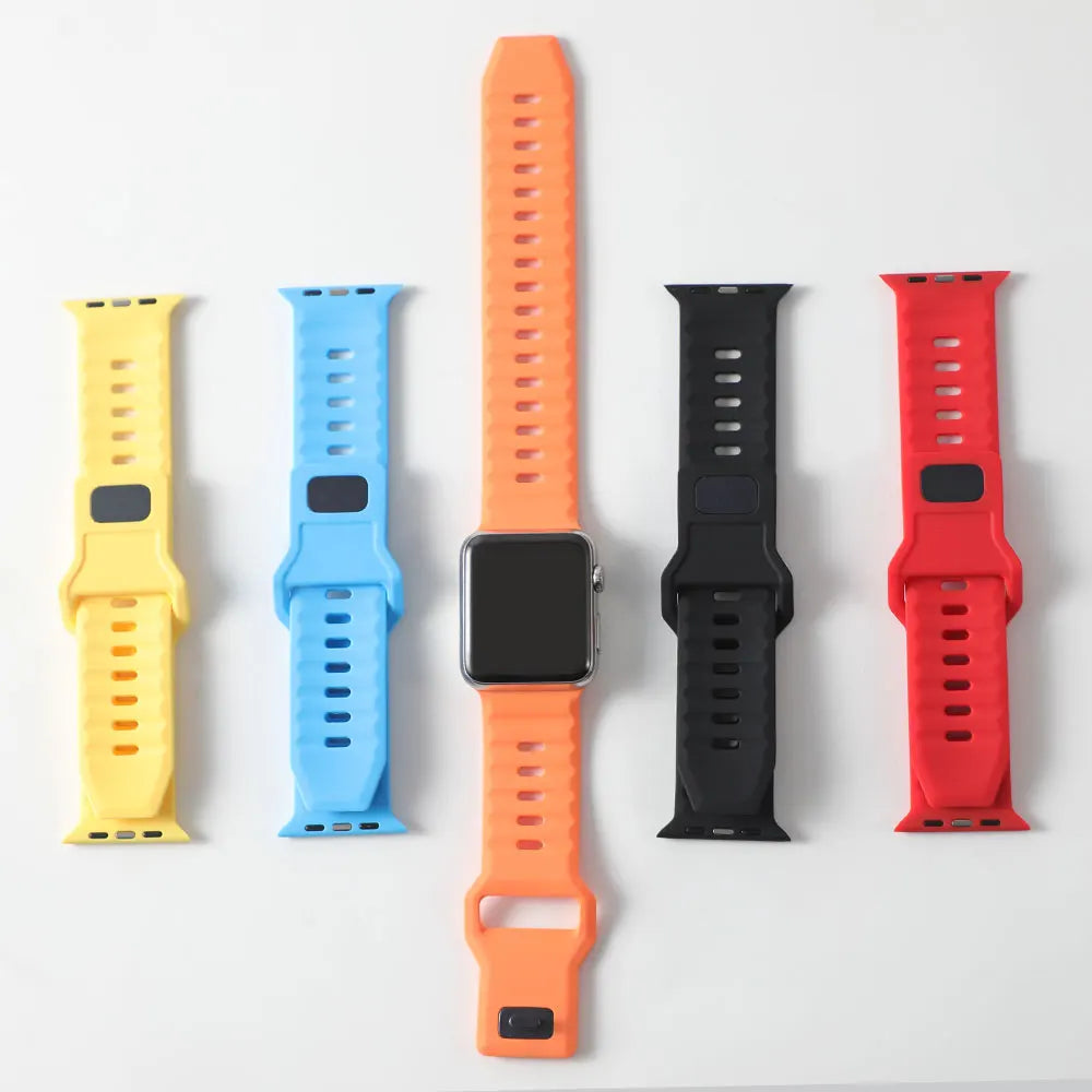 Five different colored silicone watch straps arranged in a row.