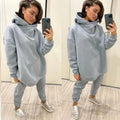 A light blue two-piece tracksuit with an oversized hooded sweatshirt and sweatpants