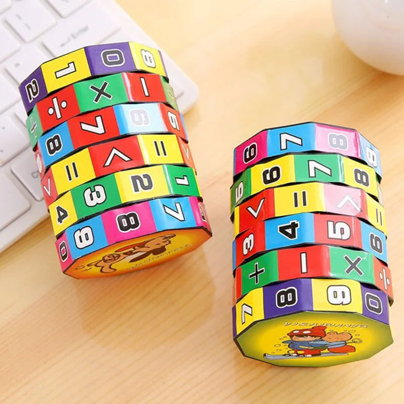 Two math cylinder puzzle toys with numbers and operators on a desk surface