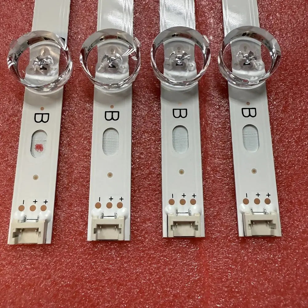 Close-up of LED backlight strip components for TV repair with clear lenses and electrical connectors