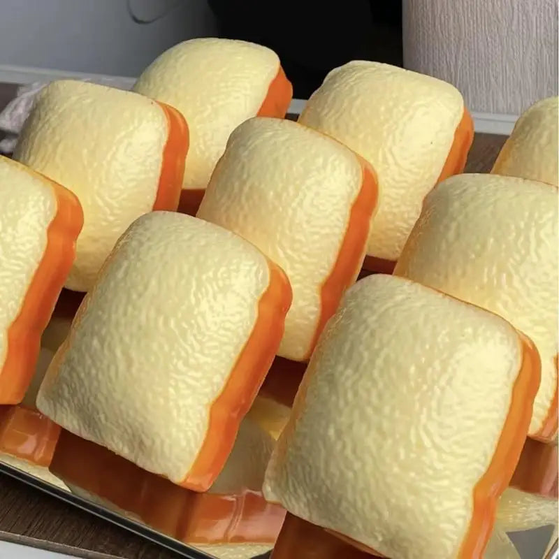 A collection of yellow and orange toast shaped squishy toys