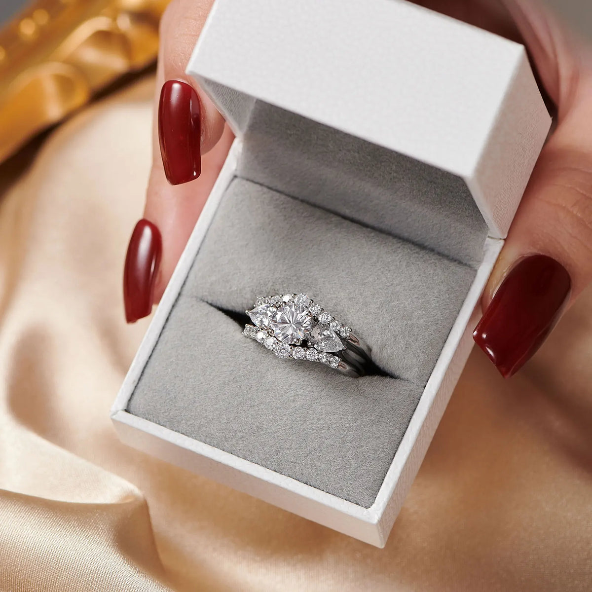 Three-piece simulated diamond sterling silver wedding ring set in a jewelry box