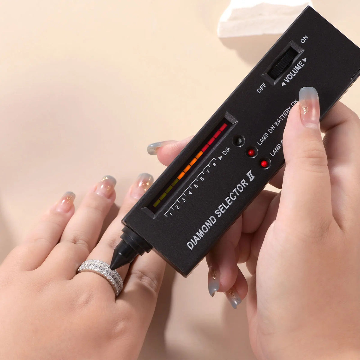 Person using a diamond tester on a moissanite wedding ring