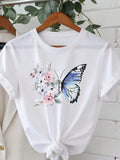 White t-shirt with floral butterfly graphic print hanging on a wooden hanger