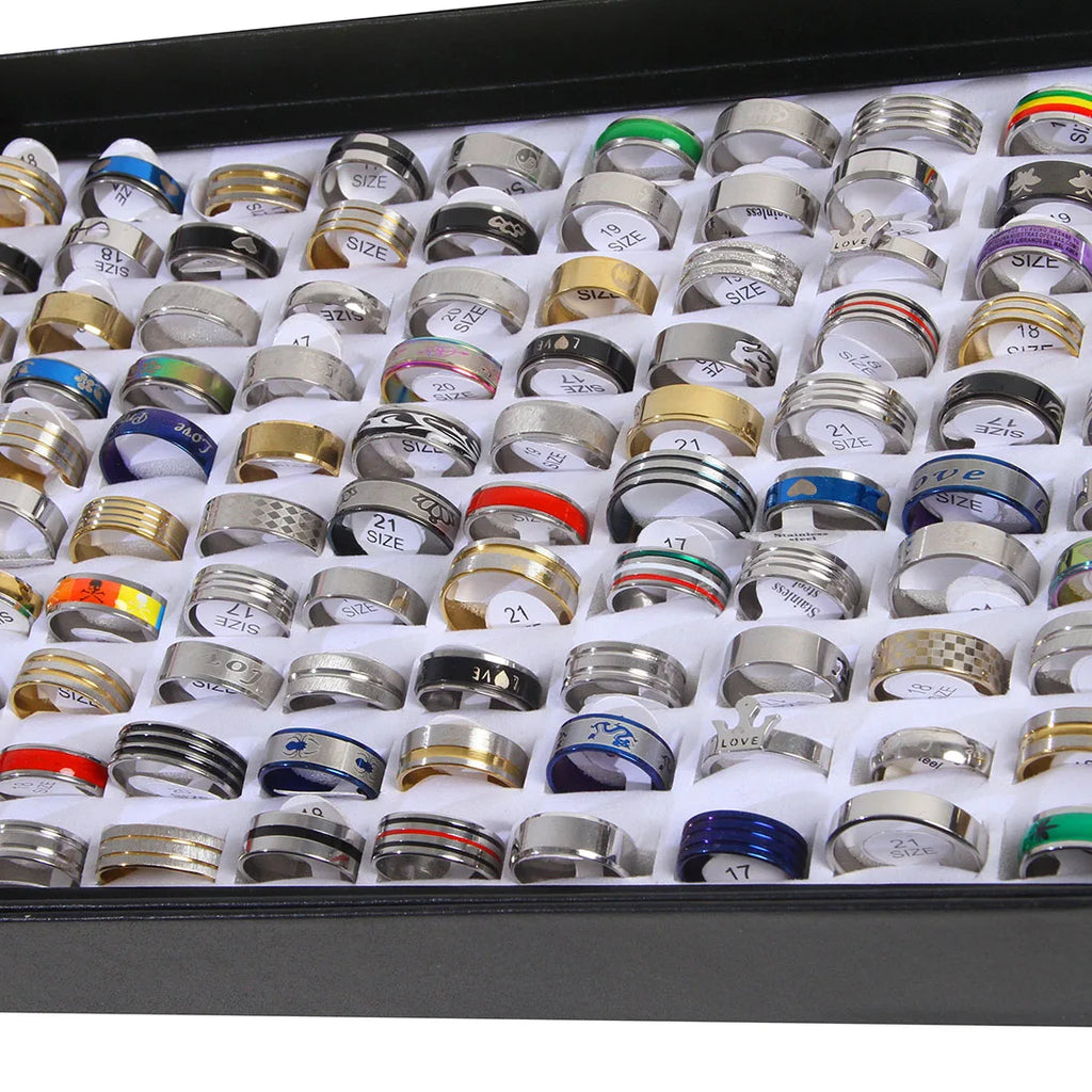 A large selection of various metal ring styles in a display tray for wholesale jewelry.