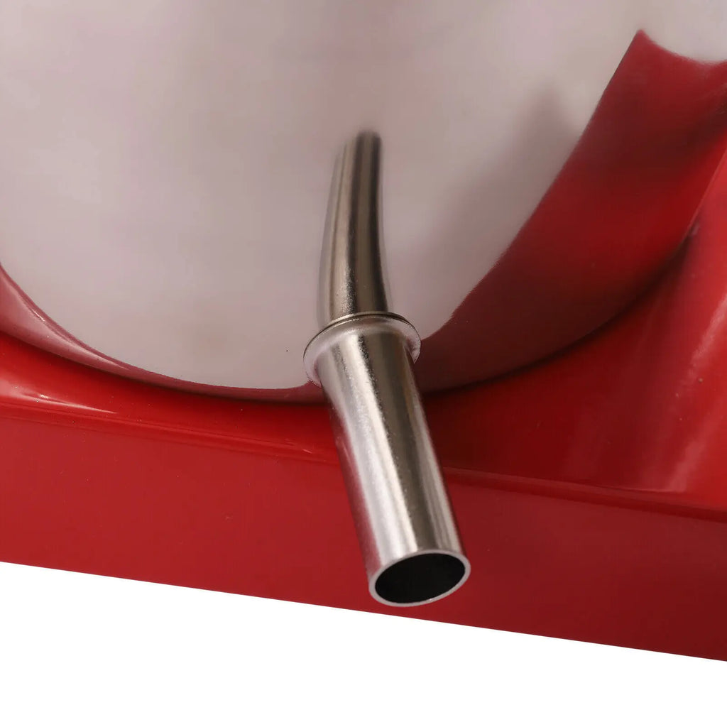 Close up of the discharge spout on a manual stainless steel fruit and herb press