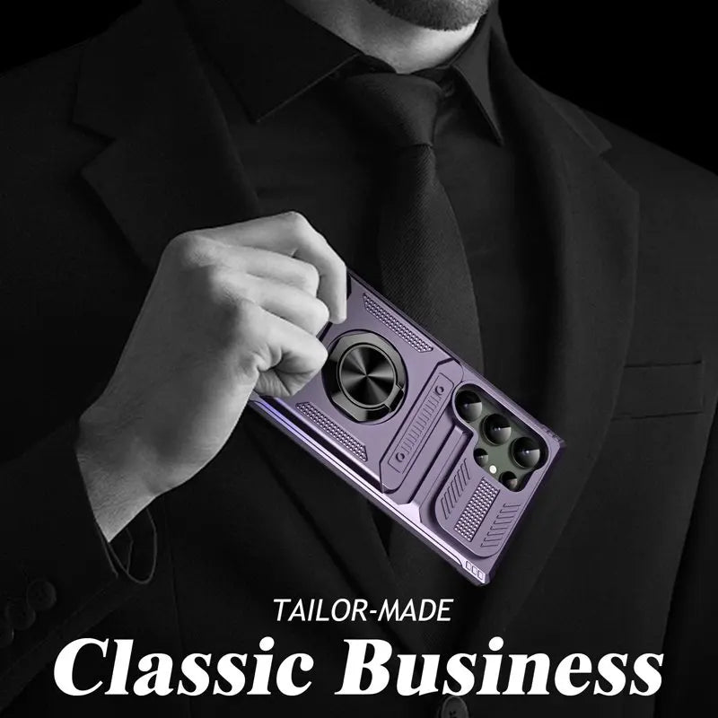A man in a black suit holding a purple protective phone case with a ring stand.