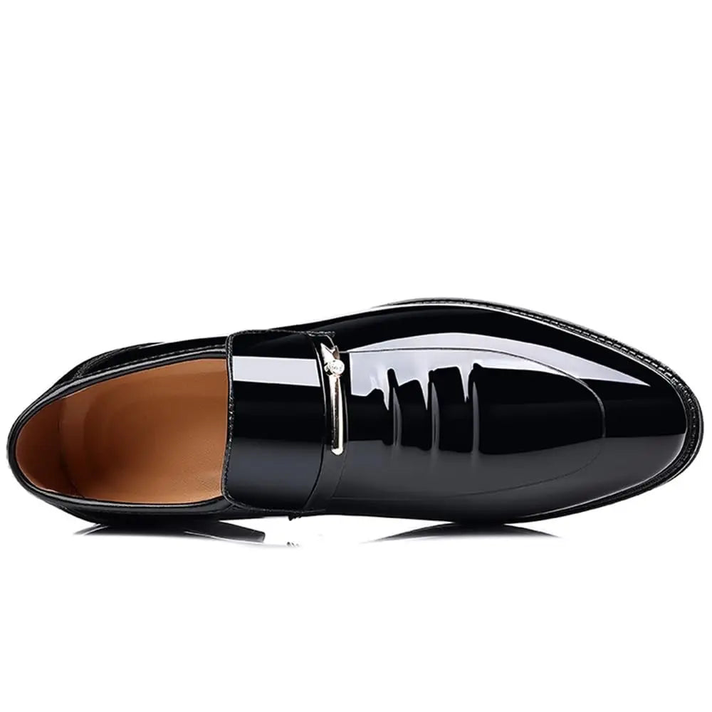 Top down view of a single glossy black patent leather mens dress shoe with a metal buckle detail.