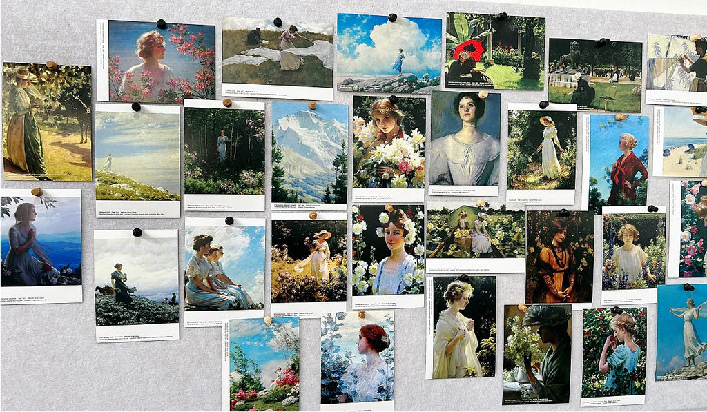 Multiple art postcards featuring female figures and landscape oil paintings displayed on a board.