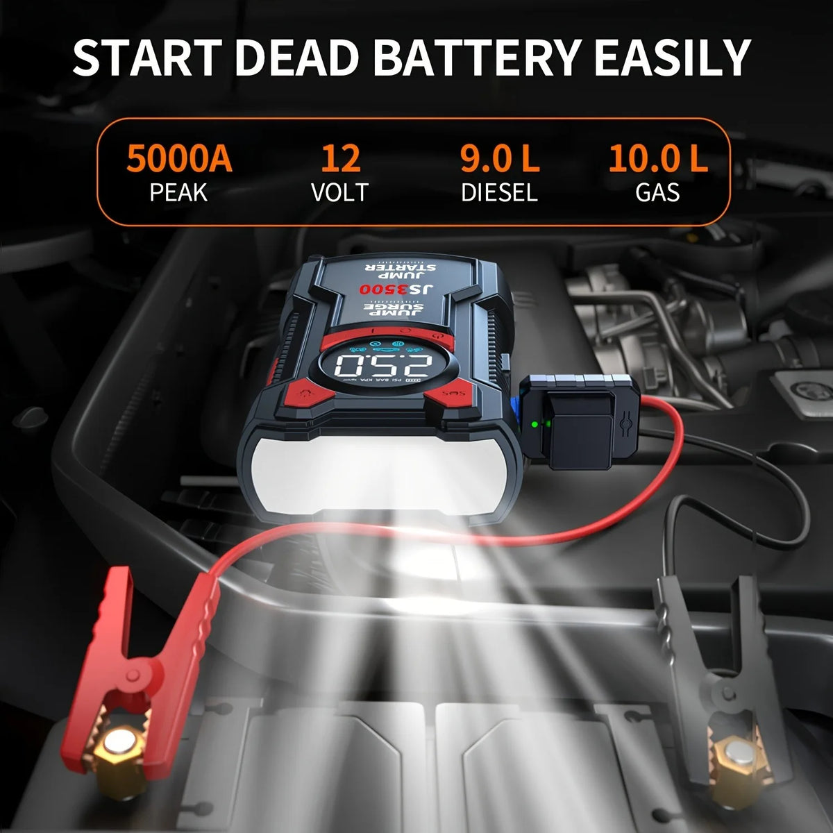 High-powered portable battery jump starter with clamps connected to a car engine battery