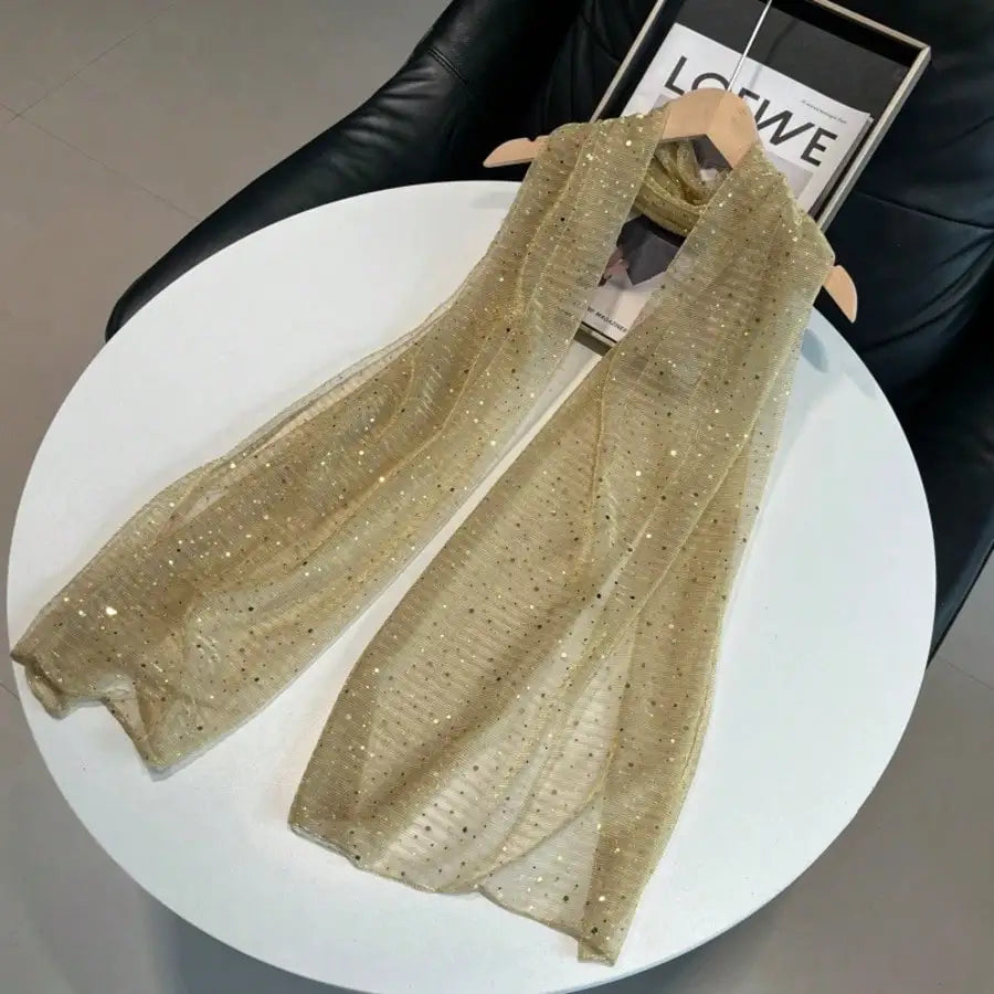 Gold sequin lightweight scarf on a hanger