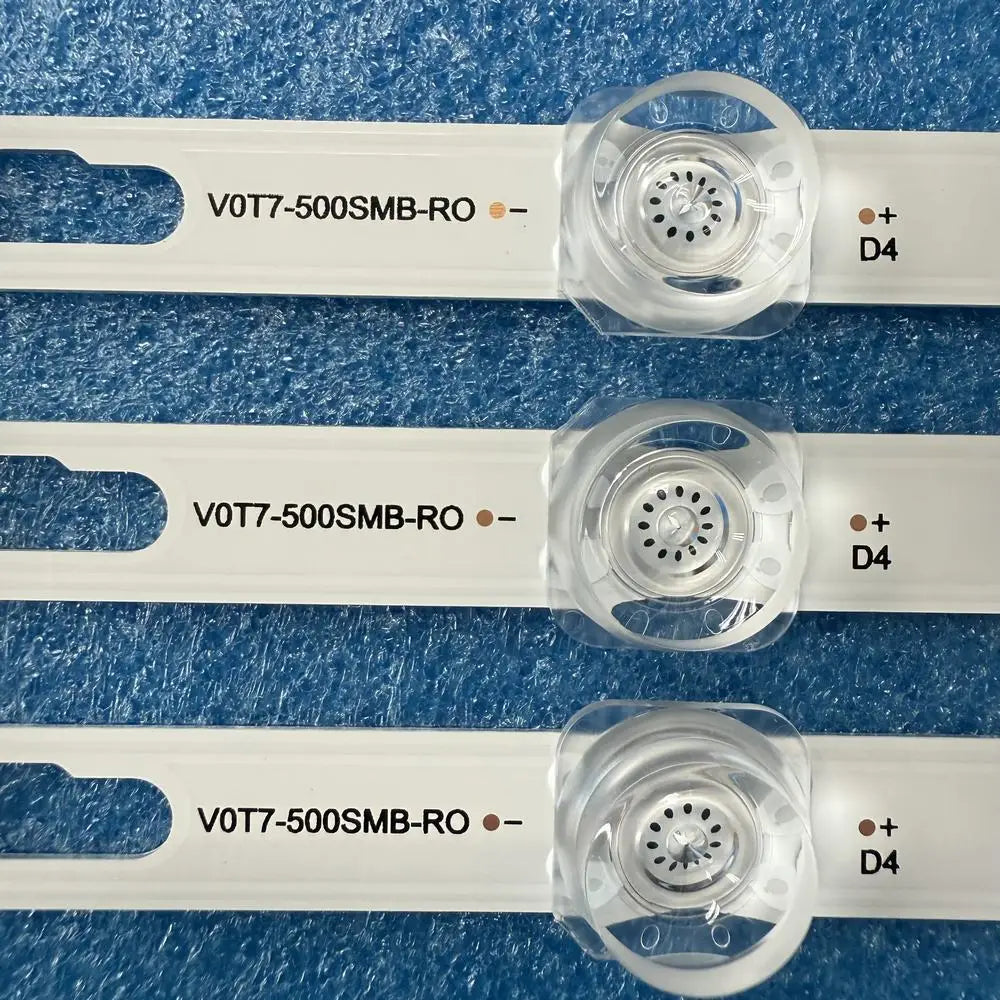 Close-up of three LED backlight strips showing component details and markings.