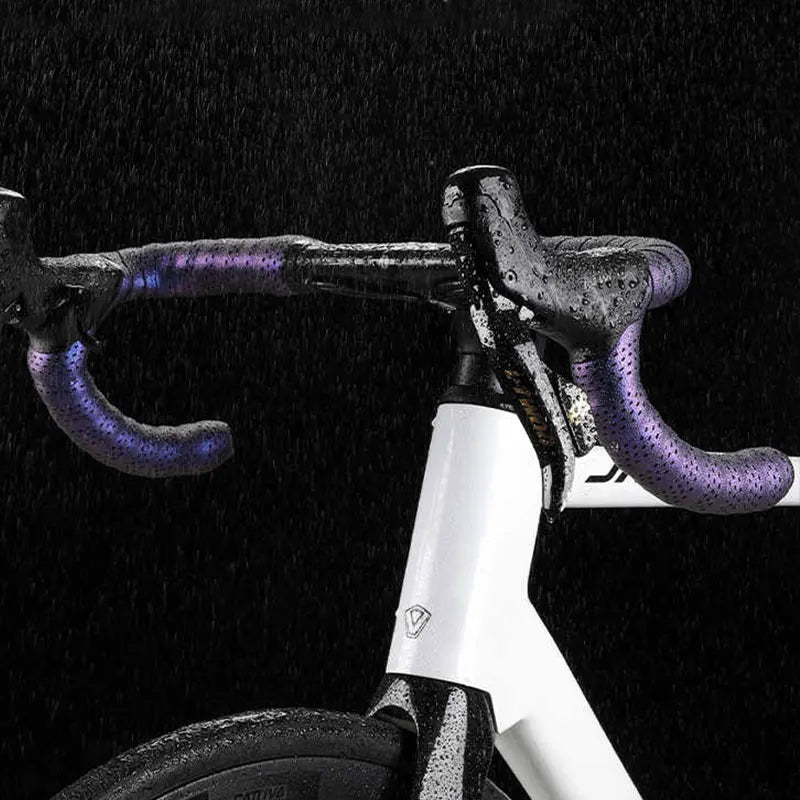 Iridescent bike handlebar tape on a road bike during heavy rain.
