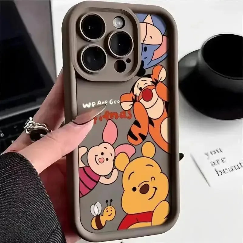 Dark grey phone case with cartoon character illustrations held in a hand