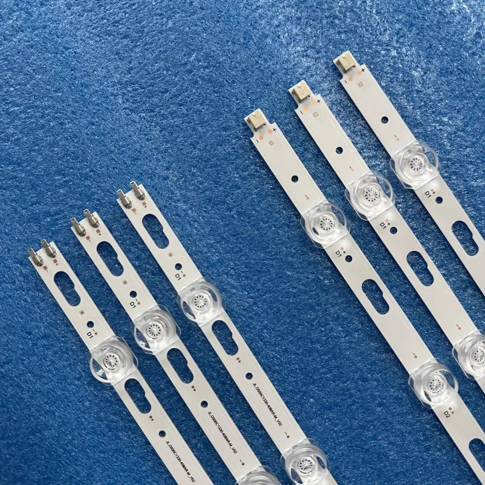 Close-up of six LED backlight strip connectors and lens assemblies.