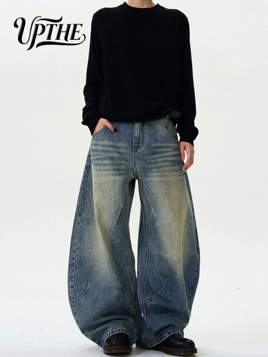 Model wearing vintage washed baggy wide leg denim jeans with black long sleeve shirt