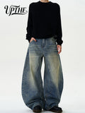 Model wearing vintage washed baggy wide leg denim jeans with black long sleeve shirt